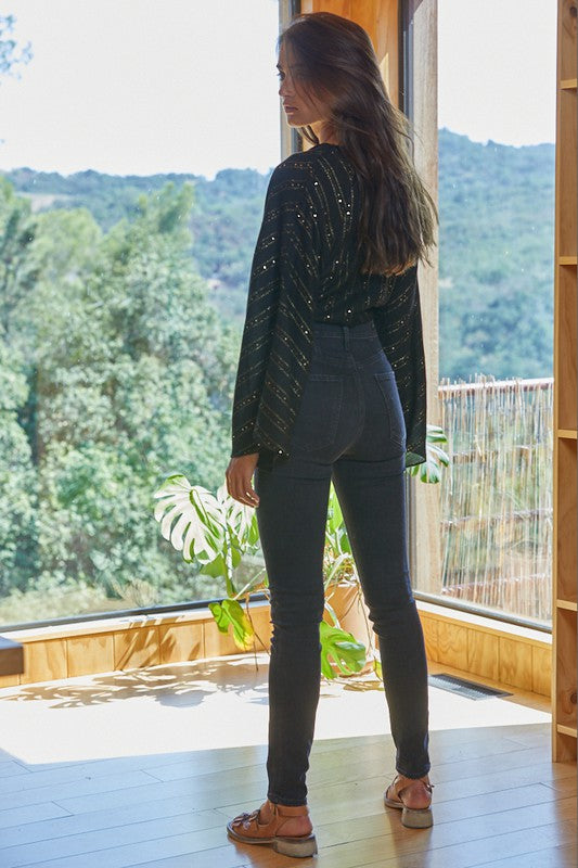 a woman standing in front of a window