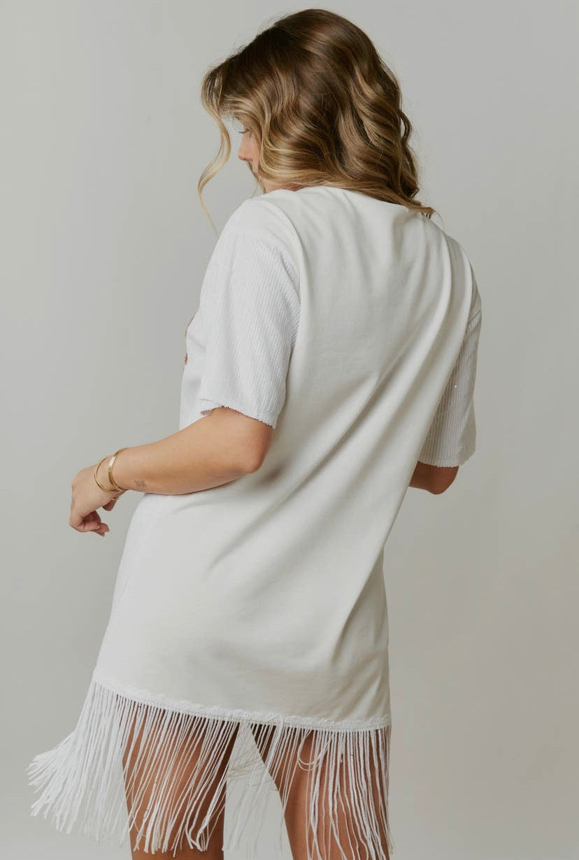 a woman wearing a white fringe dress