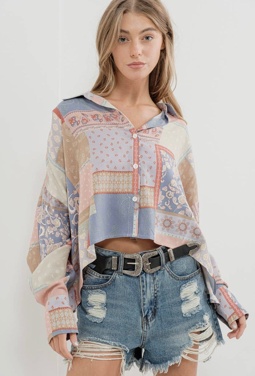 a woman wearing a top with a patchwork pattern