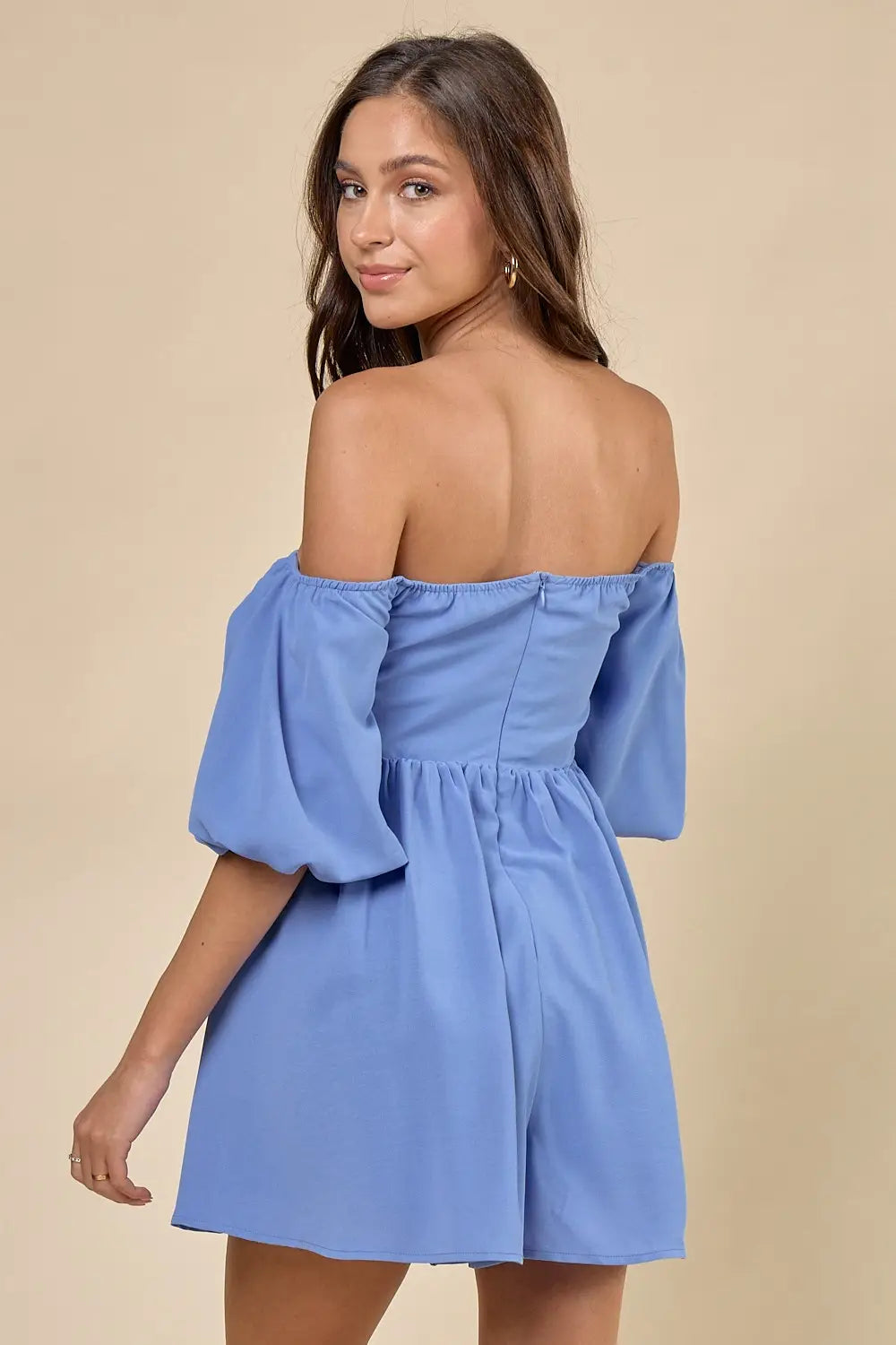 a woman in a blue dress is posing for the camera