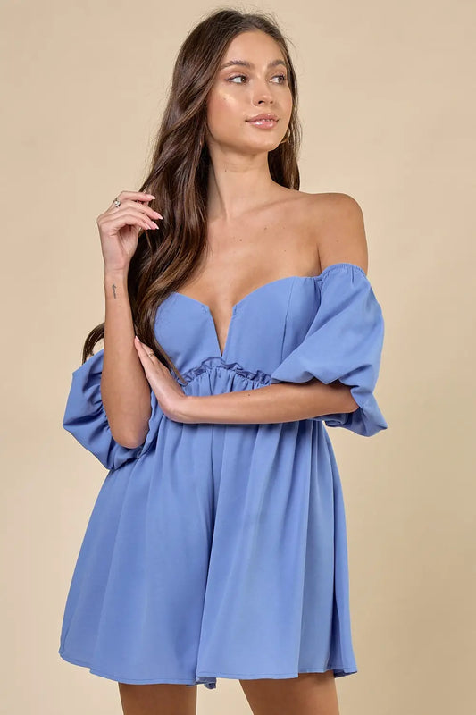 a woman in a blue dress posing for the camera